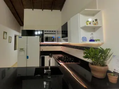 a kitchen with a sink and a stove at Azulejo - Guest House in Medellín