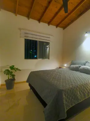 a bedroom with a bed and a window at Azulejo - Guest House in Medellín