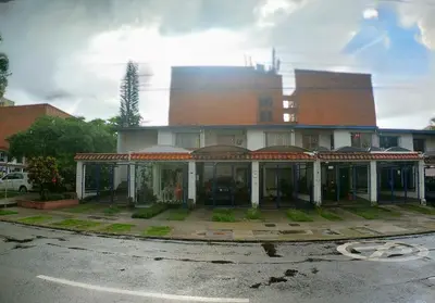 a large building with a lot of windows on a street at Azulejo - Guest House in Medellín