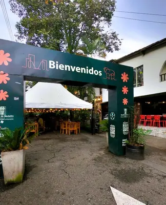 a sign for a restaurant with tables and chairs at Azulejo - Guest House in Medellín