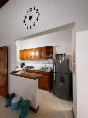 a kitchen with a refrigerator and a clock on the wall at Apartamento 501 in Itagüí