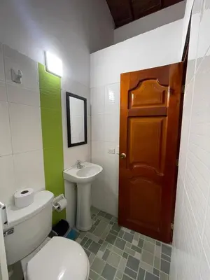 a bathroom with a toilet and a sink and a door at Apartamento 501 in Itagüí
