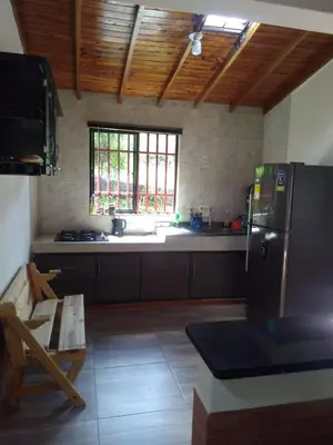 a kitchen with a stainless steel refrigerator and a window at Villa Yolanda in Girardota
