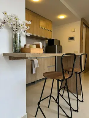 a kitchen with a table and a chair and a counter at Great Apto in Poblado in Medellín