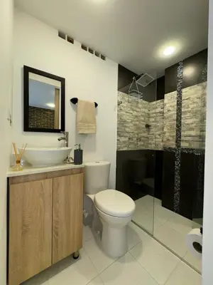 a bathroom with a toilet and a sink and a shower at Great Apto in Poblado in Medellín