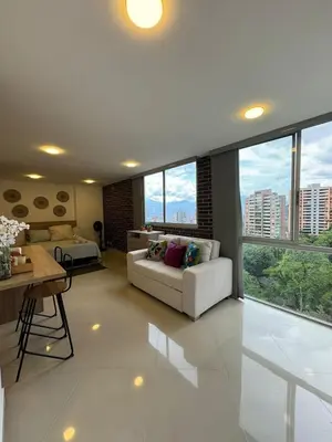 a living room with a couch and some windows at Great Apto in Poblado in Medellín