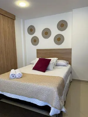 a bedroom with a bed with towels on it at Great Apto in Poblado in Medellín