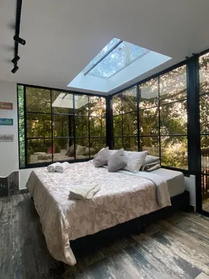 a bedroom with a large bed with a large window at nido de montaña in Copacabana