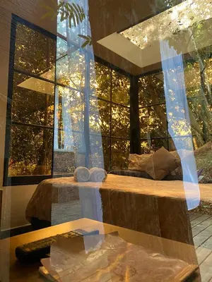 a room with two beds and a window with lights at nido de montaña in Copacabana