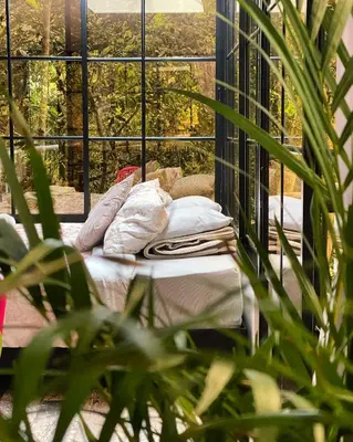 a bed in front of a large window at nido de montaña in Copacabana