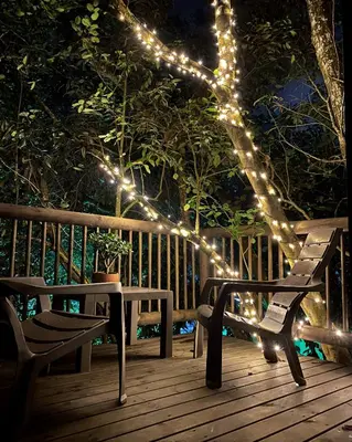 a string of lights on a bench on a deck at nido de montaña in Copacabana