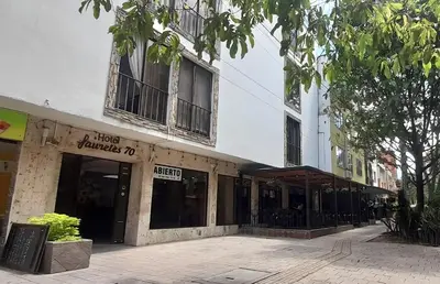 a store front of a building on a street at Hotel Laureles 70 Medellín in Medellín