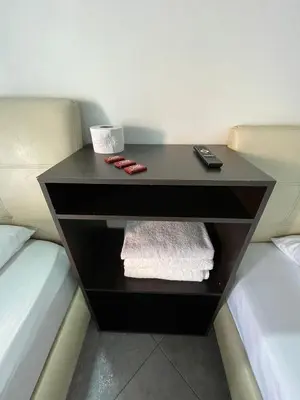 a black table with a remote control on a bed at Hotel boutique San Pablo H3 in Medellín