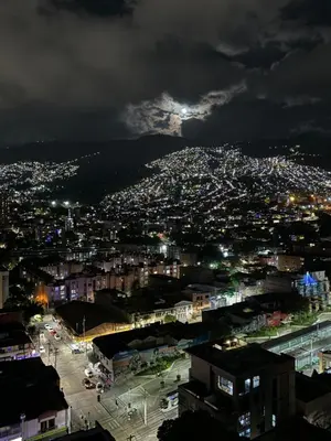 a view of a city at night at Loft luminoso y moderno con excelentes vistas in Medellín