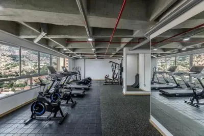 a gym with treadmills and exercise equipment in a building at Loft luminoso y moderno con excelentes vistas in Medellín