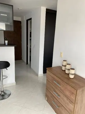 a living room with a wooden dresser with pots on it at En la cima y en el corazón de Medellín in Medellín