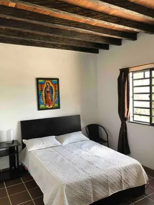a bedroom with a white bed and a window at Desconéctate! Casa de campo con vista sensacional !!! in Rionegro