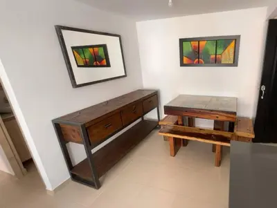 a room with a wooden desk and a table at Apartamento campestre a 5 min del parque in La Ceja