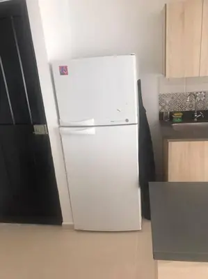 a white refrigerator in a kitchen with at Apartamento campestre a 5 min del parque in La Ceja