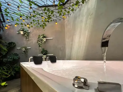 a bathroom with a sink with water coming out of it at 202 Romantic loft with jacuzzi in Medellín