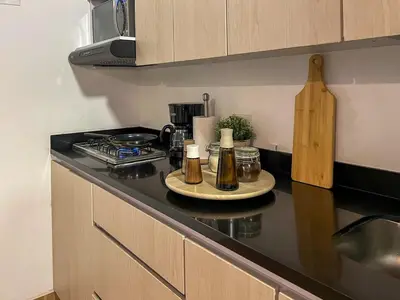 a kitchen with a counter top with bottles on it at 202 Romantic loft with jacuzzi in Medellín