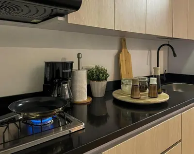 a kitchen counter with a frying pan on a stove at 202 Romantic loft with jacuzzi in Medellín