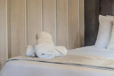 a pile of towels sitting on top of a bed at 203 Enigmatic Loft with Jacuzzi in Medellín