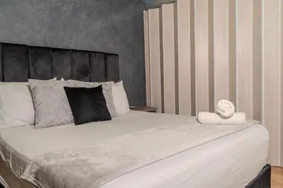 a bedroom with a large white bed with a headboard at 203 Enigmatic Loft with Jacuzzi in Medellín