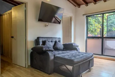 a living room with a couch and a flat screen tv at 203 Enigmatic Loft with Jacuzzi in Medellín