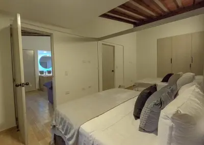 a white bedroom with two beds in a room at 203 Enigmatic Loft with Jacuzzi in Medellín