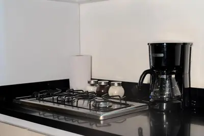 a stove top with a coffee maker on top of it at 203 Enigmatic Loft with Jacuzzi in Medellín
