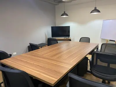 a conference room with a wooden table and chairs at Económicas habitaciones amobladas en Medellín con oficinas, puesto de trabajo, cocina, baño y lavandería comunes Be Together by Roots Rentals TOG401y402 in Medellín