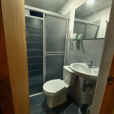 a bathroom with a toilet and a sink at Apartamento en Jardín Antioquia in Jardin