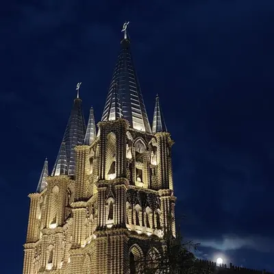 a building with a clock tower at night at Apartamento en Jardín Antioquia in Jardin