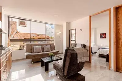 a large living room with a couch and a bed at Apartamento centro Marinilla in Marinilla