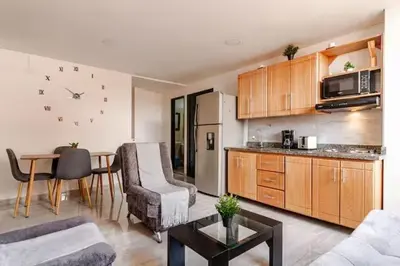 a living room with a kitchen and a dining room at Apartamento centro Marinilla in Marinilla