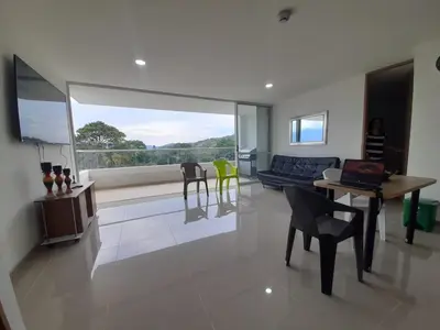 a living room with a couch and a table and chairs at Disole 504 in Santa Fe de Antioquia