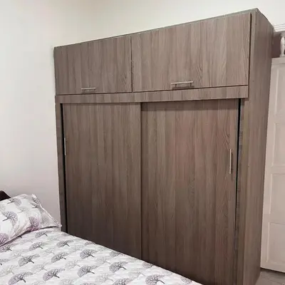 a large wooden cabinet in a bedroom with a bed at Casa Familiar- Turística Manríque Medellín in Medellín