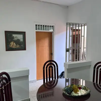 a dining room with a table with a plate of food on it at Casa Familiar- Turística Manríque Medellín in Medellín