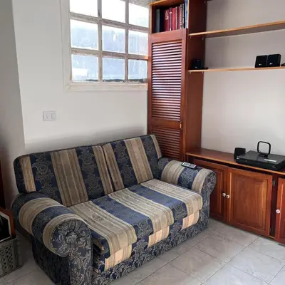 a living room with a couch and a window at Casa Familiar- Turística Manríque Medellín in Medellín