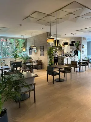 a restaurant with tables and chairs and a kitchen at Great view apartment in El Poblado in Medellín