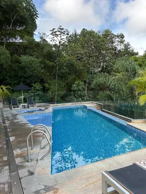 a large swimming pool with blue water at Great view apartment in El Poblado in Medellín