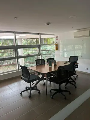 a conference room with a wooden table and chairs at Great view apartment in El Poblado in Medellín