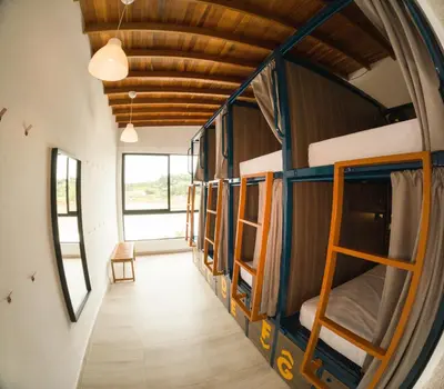 a room with a bunch of bunk beds in it at Viajero Guatapé Hostel & Lake Club in Guatapé
