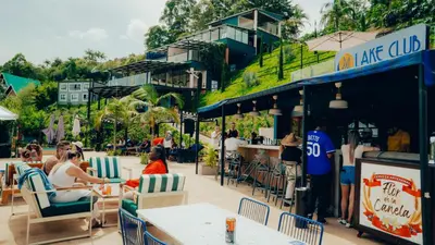 a group of people sitting at tables at a restaurant at Viajero Guatapé Hostel & Lake Club in Guatapé