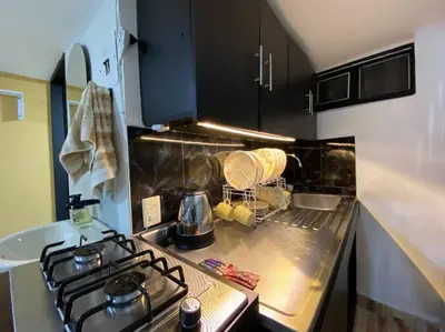 a kitchen with a stove and a counter top at Harmony loft - Apto con Wifi de 200Mbp Cercano a todo in Carmen de Viboral
