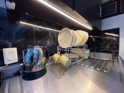 a kitchen with a counter with plates and a blender at Harmony loft - Apto con Wifi de 200Mbp Cercano a todo in Carmen de Viboral