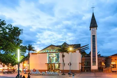 a large building with a clock tower in front of it at Harmony loft - Apto con Wifi de 200Mbp Cercano a todo in Carmen de Viboral