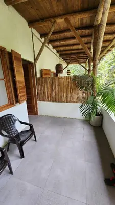 a patio with a chair and a plant in a building at Casa Kiwi Jungle Lodge in San Francisco