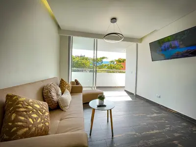 a living room with a couch and a table at Apt luxe laurles estadio 3alcobas in Medellín